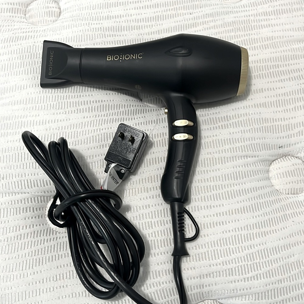 Black and gold hair dryer with labels intact